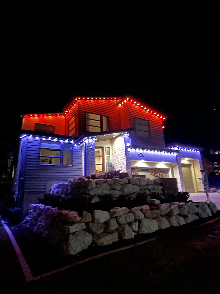 Red and blue permanent lighting on a modern home facade